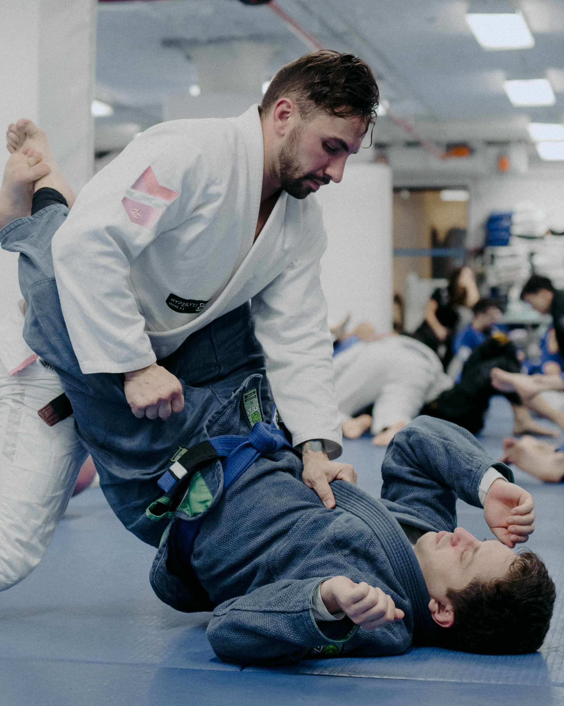 Black belt instructor demonstrating technique to a class at Renzo Gracie Jiu-Jitsu Upper West Side