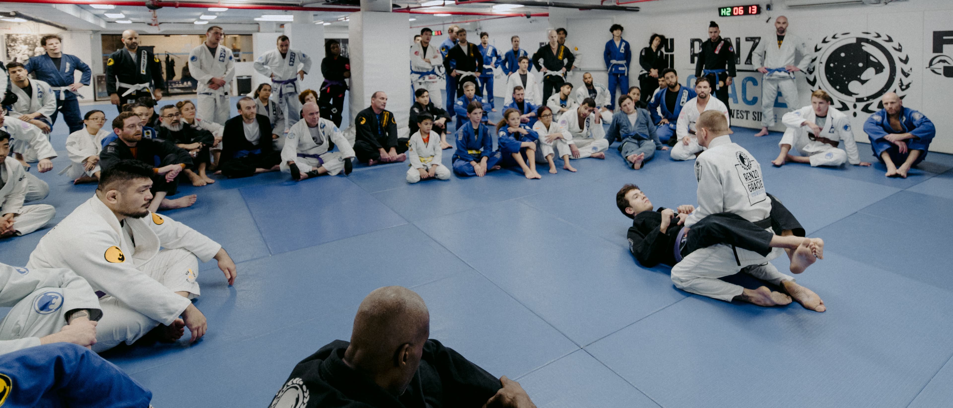 Black belt instructor demonstrating technique to a class at Renzo Gracie Jiu-Jitsu Upper West Side